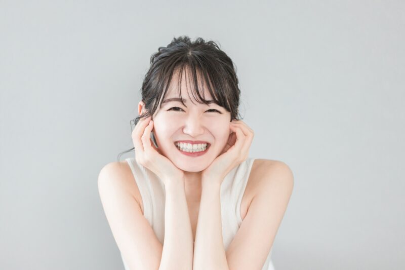 白い歯が美しい笑顔のアジア人女性