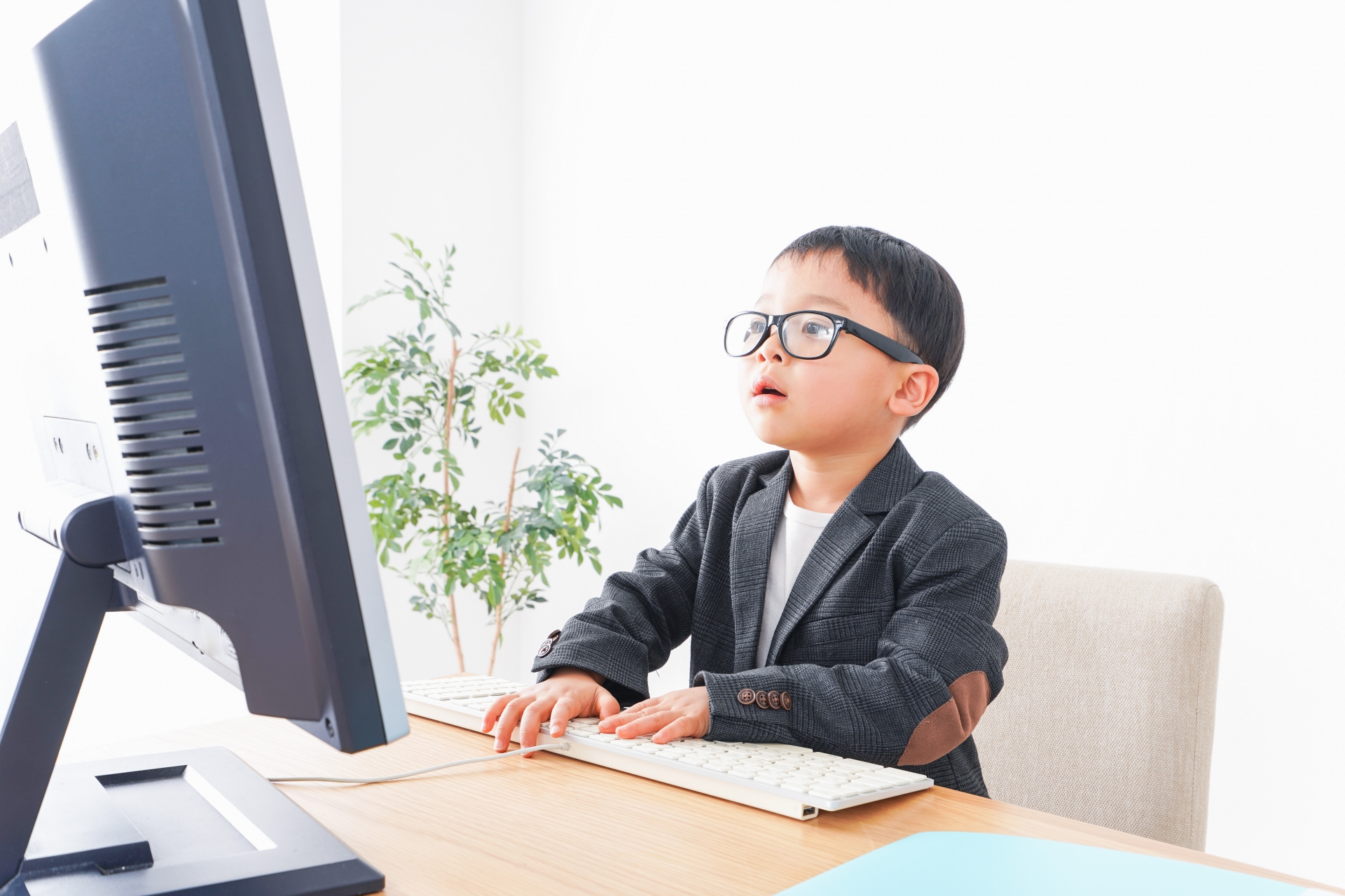 スーツを着て仕事をする子供ビジネスマン