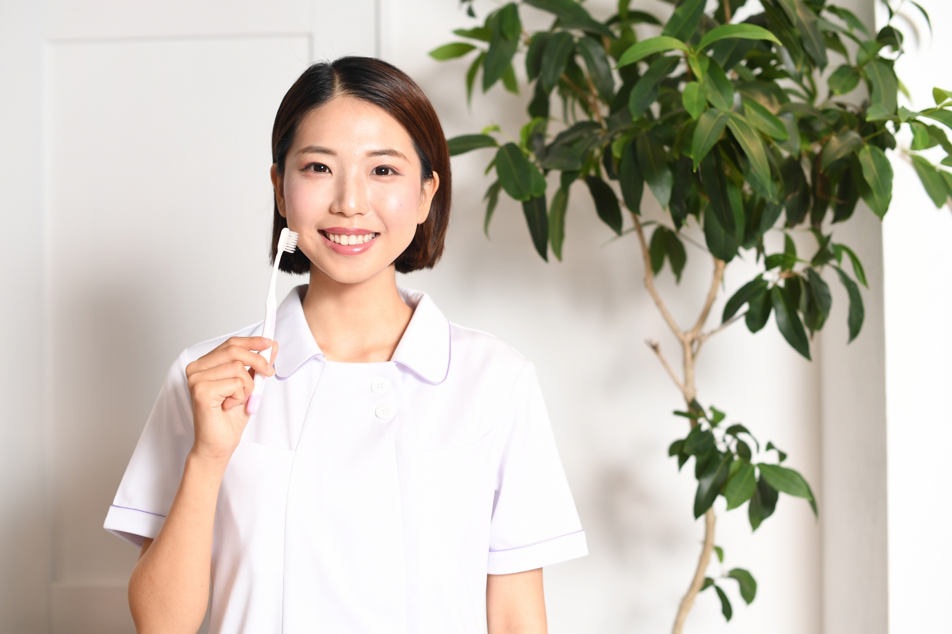 歯ブラシを持つ歯科医師の女性